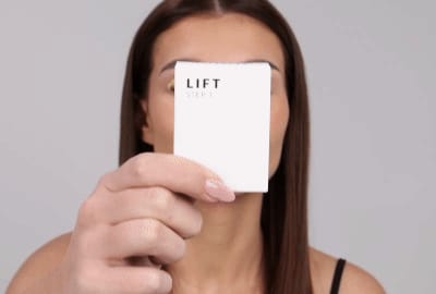 Model applying Step 1 - Lift on lashes