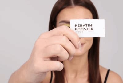 Model applying Step 3 - Keratin Booster on lashes
